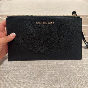 MICHAEL KORS black leather clutch with wrist strap.